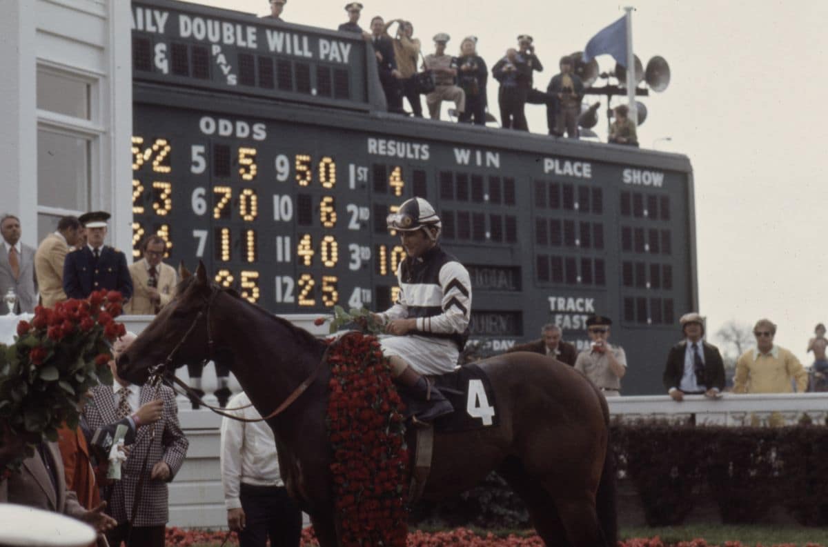Foolish Pleasure with jockey Jacinto VÃ¡squez in the winnner's circle at the 1975 Kentucky Derby / 101st running of the Kentucky Derby, Churchill Downs.