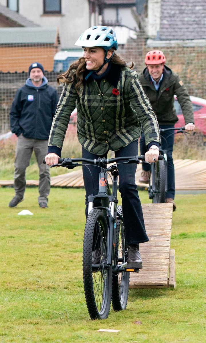 The royal couple hopped on bikes during their visit to Outfit Moray