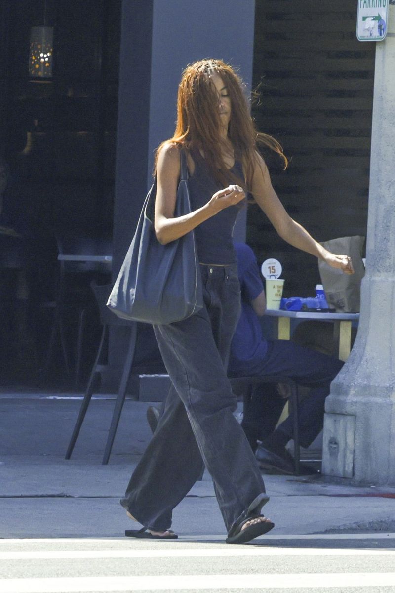 

Malia Obama is checking her manicure after a nail salon appointment. 