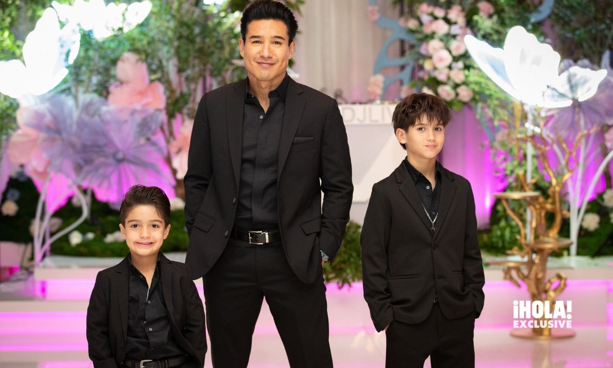 Mario Lopez posed proudly with his sons, Nico and Santino, both looking dapper in matching black suits.