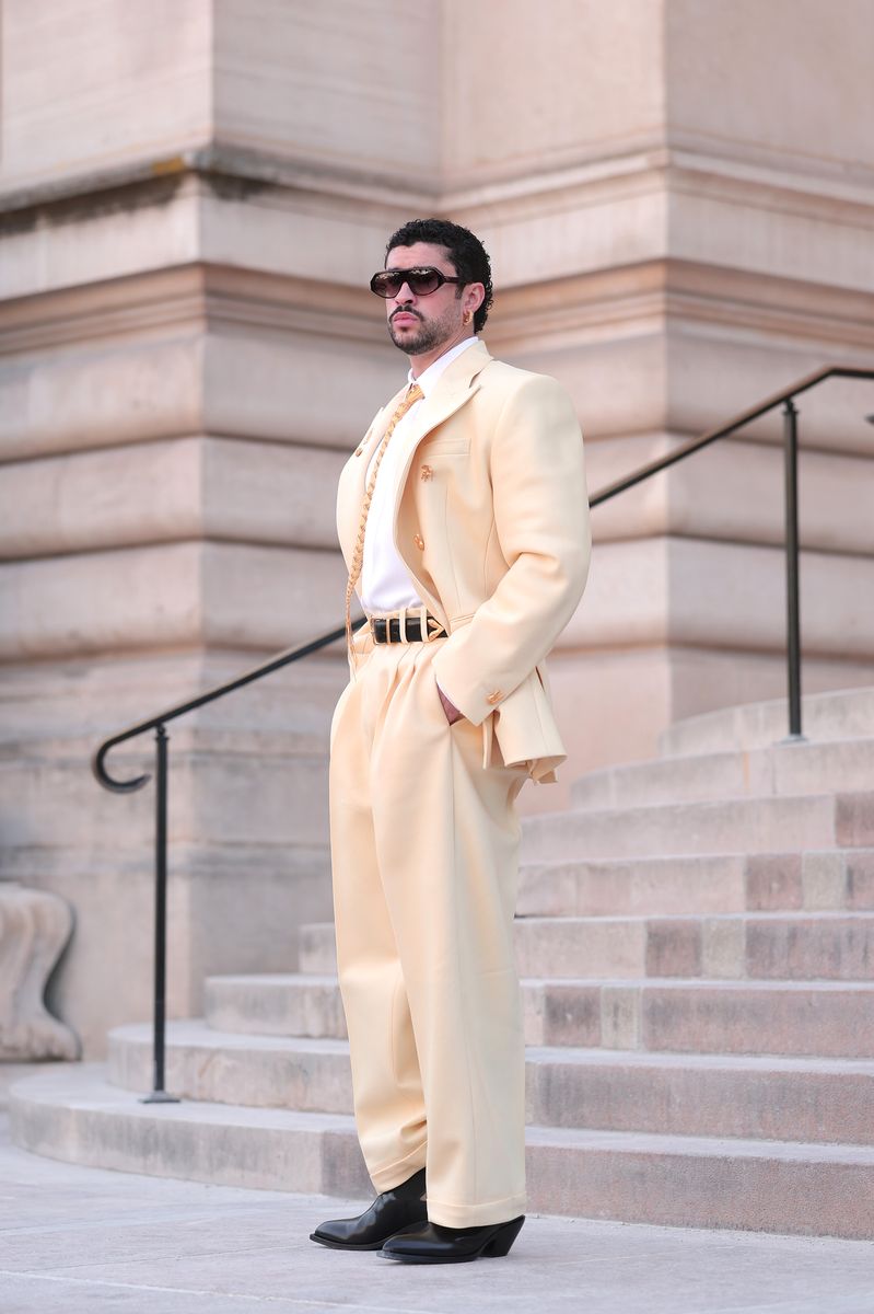 Scattered across the suit were several gold brooches that weren't simply decorative. Instead, they served as personal references to Bad Bunny's musical journey.