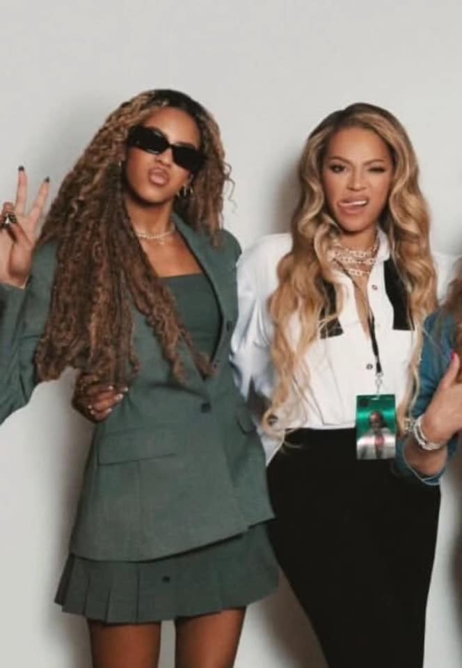 Blue Ivy towers over Beyoncé in green pleated skirt and statement jewelry during fun night out