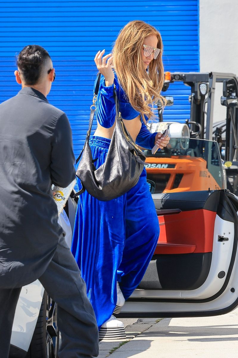 Jennifer Lopez showed off her toned abs in a velvet tracksuit and platforms