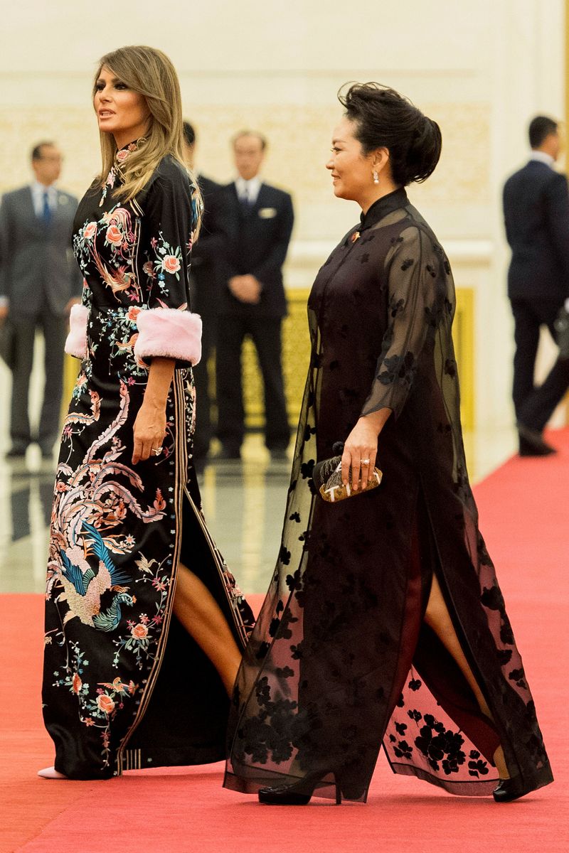 The design featured intricate floral embroidery woven with gold accents, long sleeves, a high neckline, and soft pink fur cuffs that added a theatrical finish to the ensemble. 