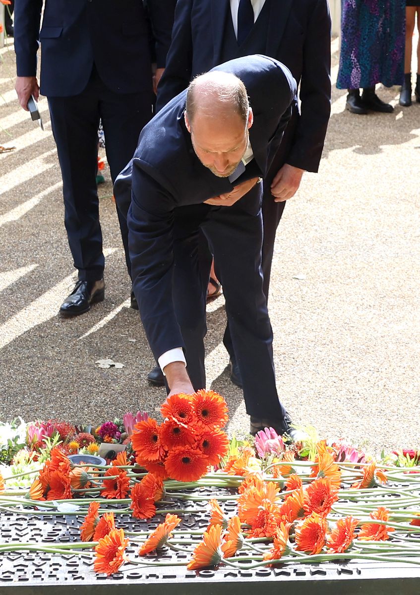 Britain's Prince William, Prince of Wales lays a bouquet of flowers as he attends a service at the 7/7 memorial in London's Hyde Park on July 7, 2025, to remember of the 52 people killed during the London bombings of July 7, 2005. Britain on Monday marks 20 years since the London bombings, when four homegrown Islamist extremists detonated suicide bombs on three underground trains and a bus across central London, killing dozens and injuring hundreds more. (Photo by Chris Jackson / POOL / AFP) (Photo by CHRIS JACKSON/POOL/AFP via Getty Images)          