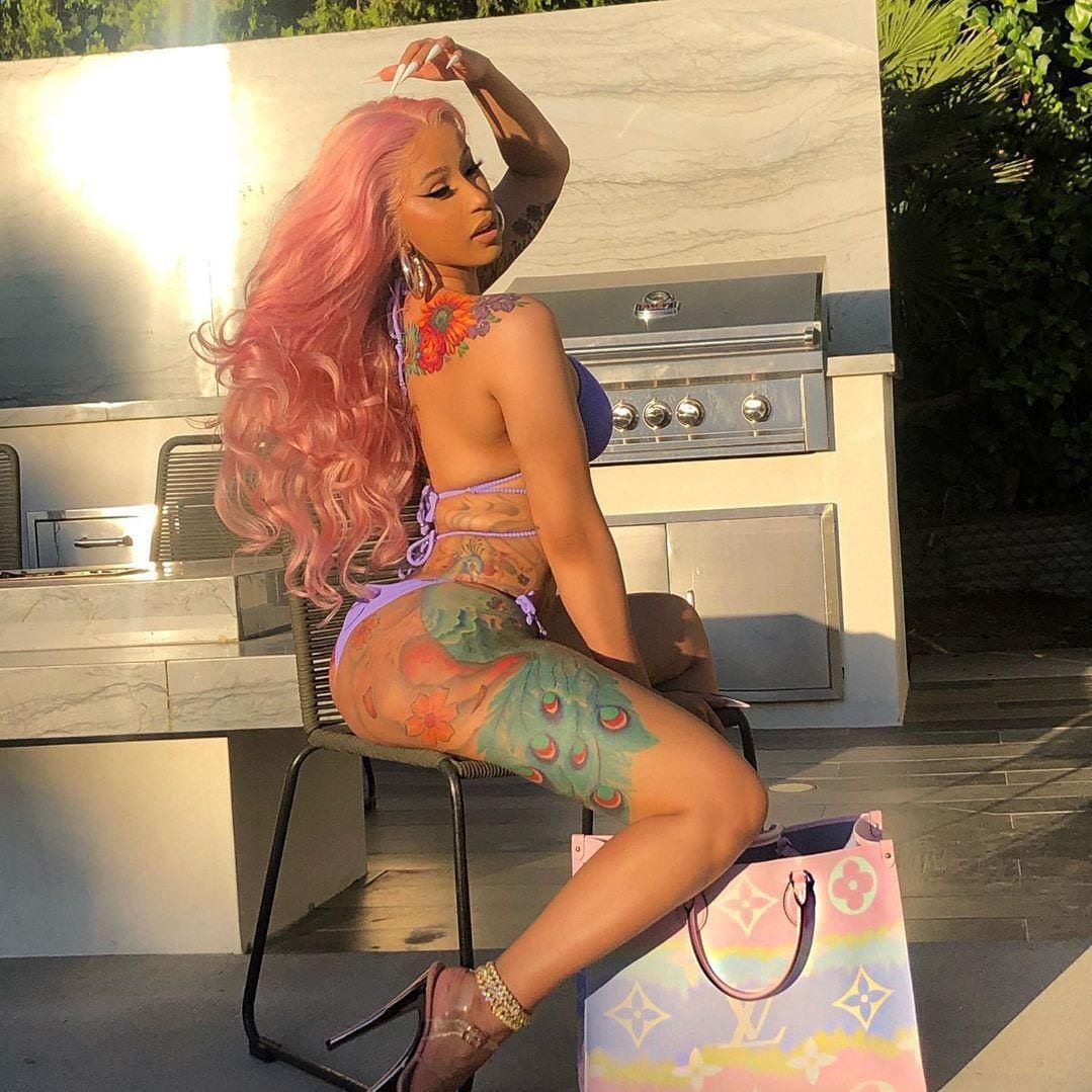 Cardi B poses in a purple bikini in backyard