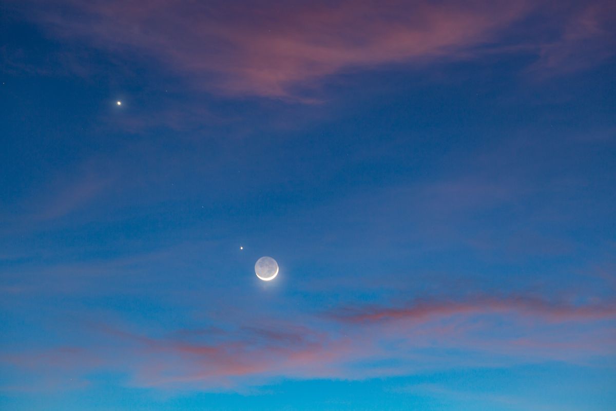 The beautiful twilight skyafter sunset with the planets conjuction of Moon (with earth shine), Venus and Jupiter.