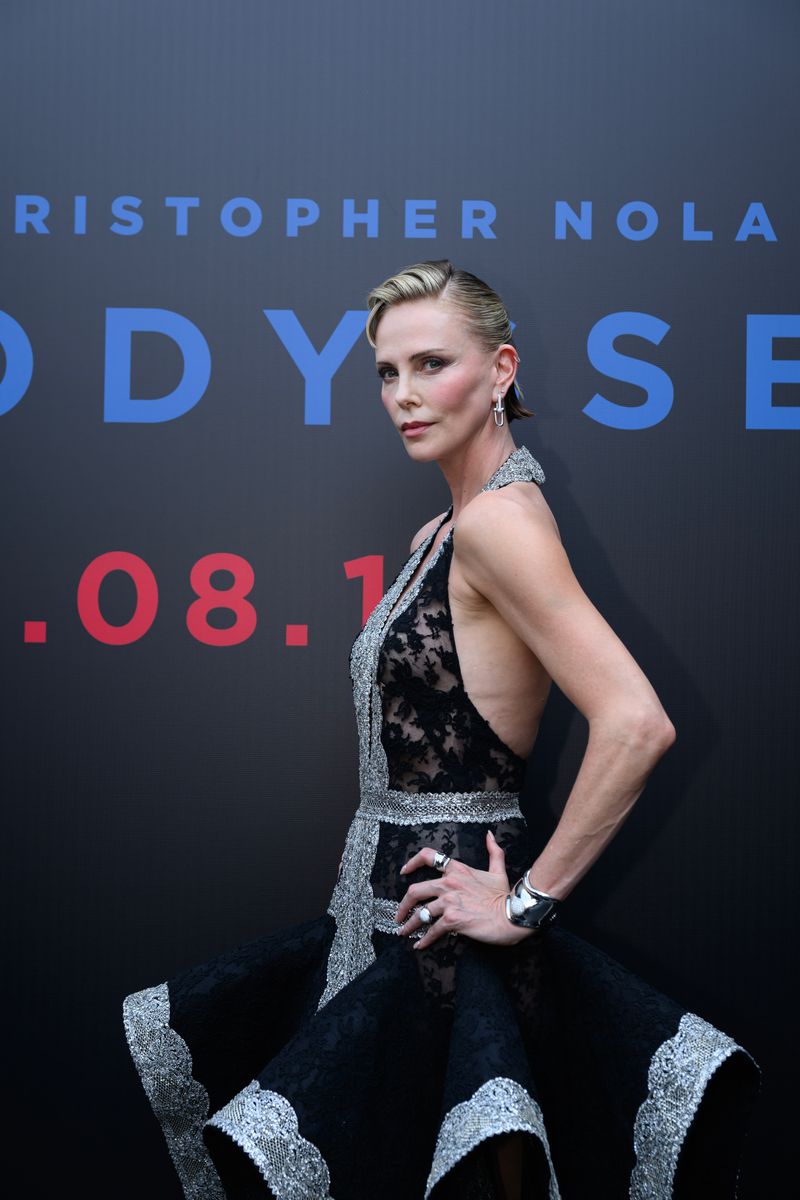 Charlize Theron debuts a dramatic new hairstyle featuring edgy baby bangs and a dimensional two-tone blonde bob while promoting The Odyssey in Beijing, China.