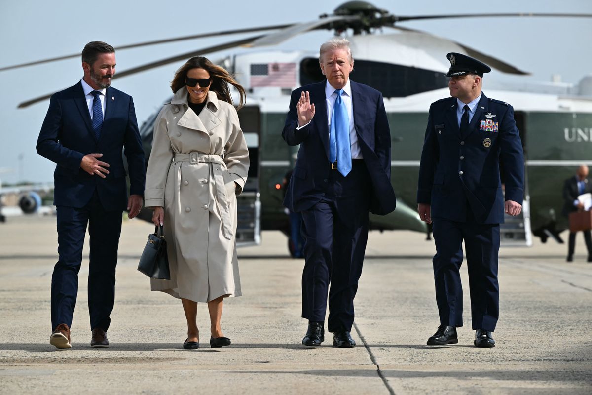 US President Donald Trump and First Lady Melania Trump make their way to board Air Force One before departing from Joint Base Andrews in Maryland on April 25, 2025. Trump is heading to Rome, Italy for the funeral for Pope Francis. The president and first lady are traveling to Rome to attend the funeral of Pope Francis. (Photo by Mandel NGAN / AFP) (Photo by MANDEL NGAN/AFP via Getty Images)          