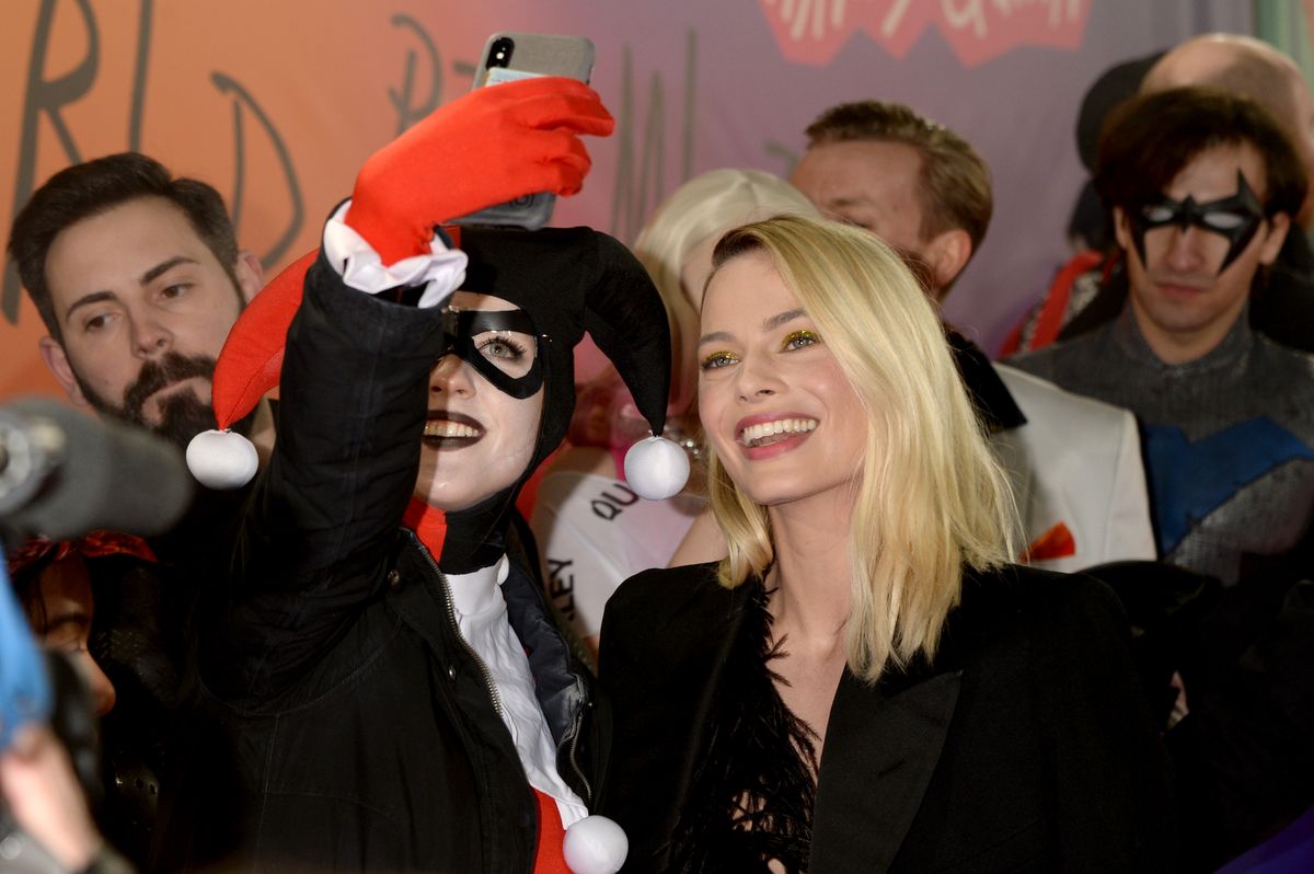 Margot Robbie poses with a fan dressed as Harley Quinn at the London premiere of “Birds of Prey” in January 2020. Fans voiced support for her portrayal after James Gunn mentioned the character in his interview.