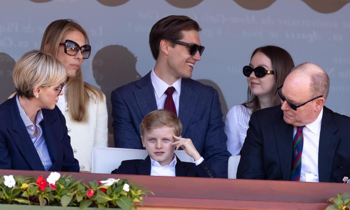 Jacques coordinated with his parents wearing a collared shirt and navy blazer.