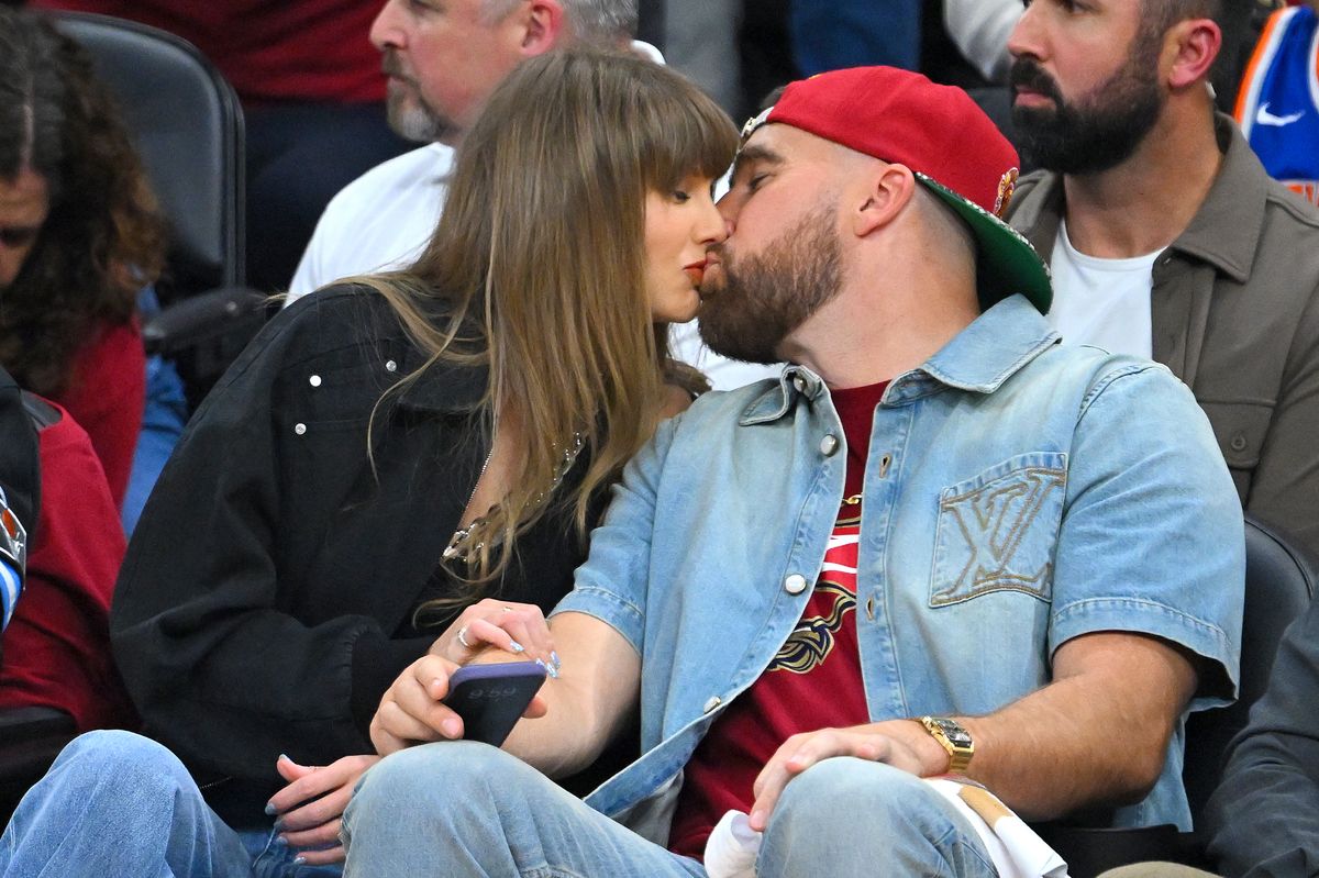 Singer Taylor Swift and Travis Kelce of the Kansas City Chiefs kiss during Game Three between the New York Knicks and the Cleveland Cavaliers in the NBA Eastern Conference Finals at Rocket Arena on May 23, 2026 in Cleveland, Ohio. NOTE TO USER: User expressly acknowledges and agrees that, by downloading and or using this photograph, User is consenting to the terms and conditions of the Getty Images License Agreement. (Photo by Jason Miller/Getty Images)