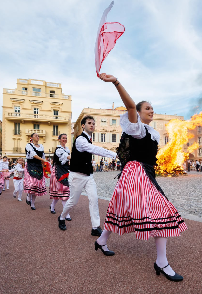 The royal family watched the celebrations from the Prince's Palace as dancers performed around the traditional Saint-Jean bonfire.