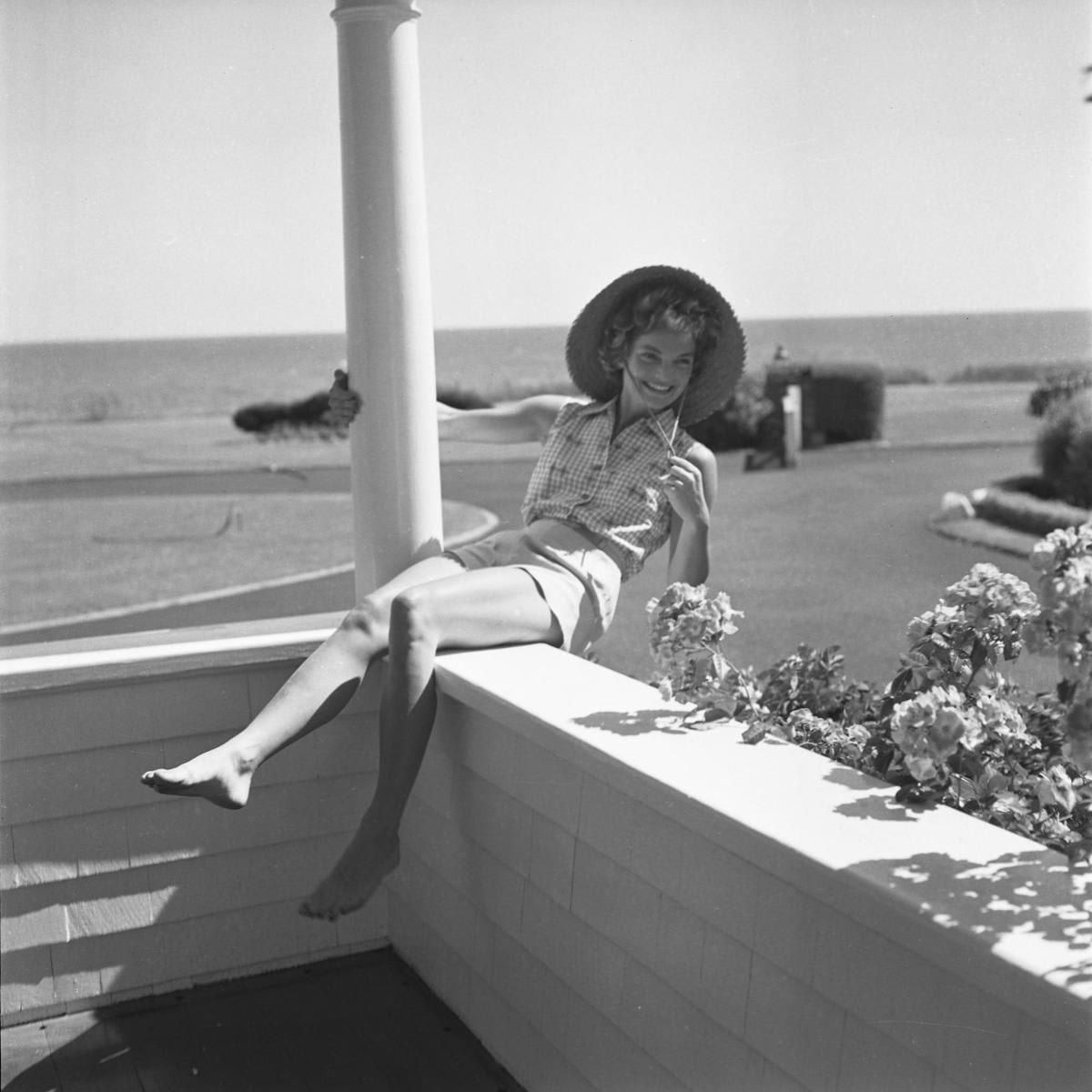 Jackie served major summer style inspiration going barefoot and donning a sleeveless gingham shirt, shorts and hat at the Kennedy compound in Hyannis Port.