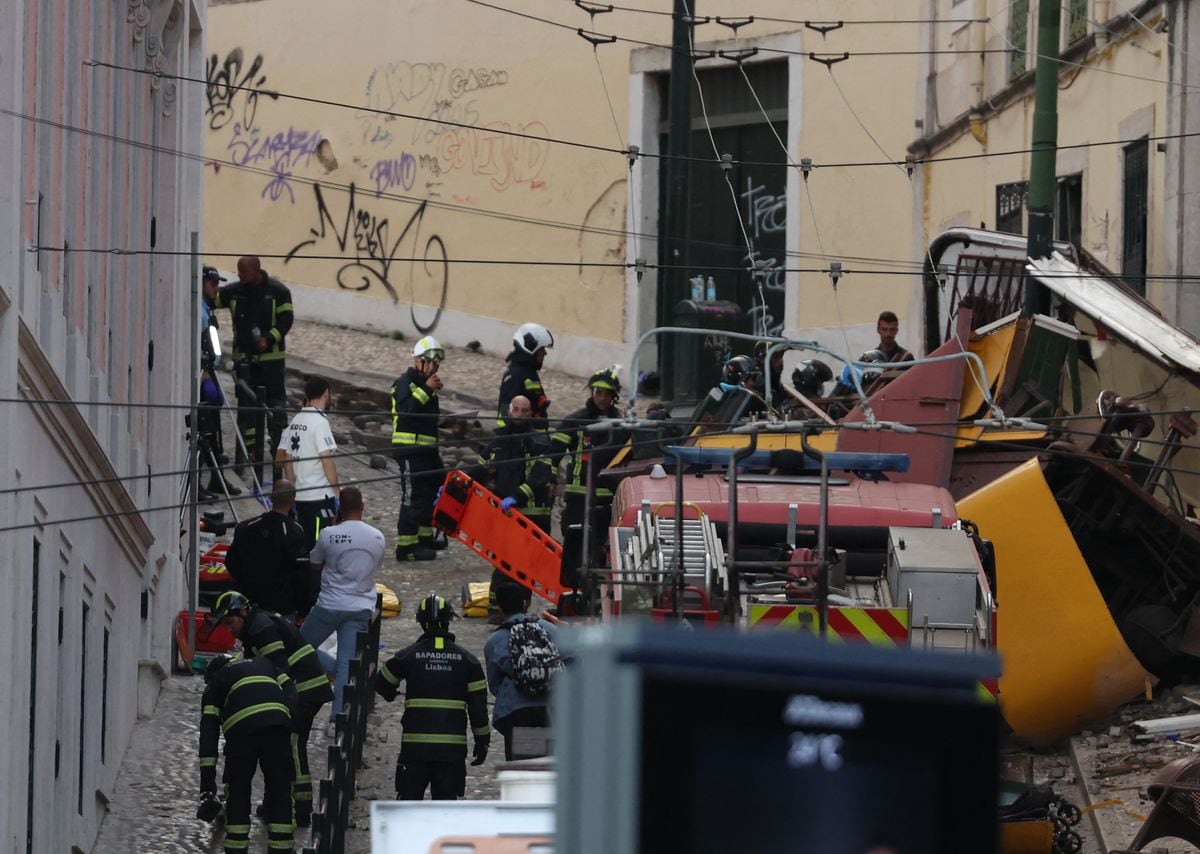 Police and firefighters work on the site of the Gloria funicular railway accident in Lisbon.