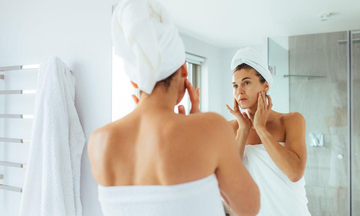 examine your skin in the bathroom