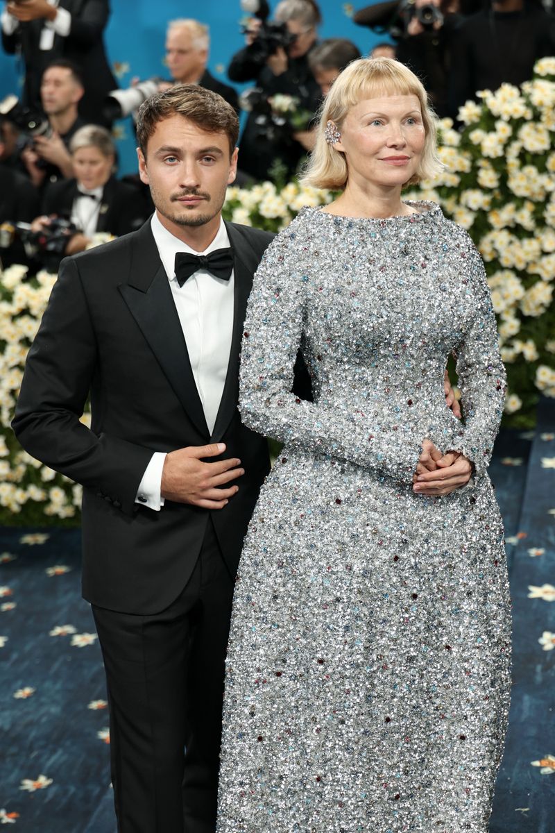 Pamela Anderson and Brandon Thomas Lee attend the 2025 Met Gala Celebrating "Superfine: Tailoring Black Style" 