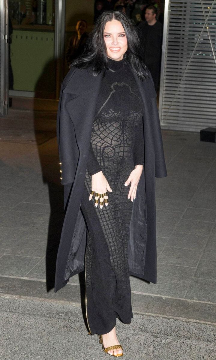 Adriana Lima Debuts Her Baby Bump In Skintight Dress At Balmain's PFW Show