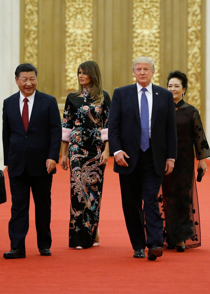 Melania stepped into the Great Hall of the People wearing a black floor-length embroidered gown by Gucci, widely described as a modern interpretation of the traditional Chinese cheongsam silhouette. 