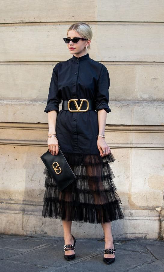 Full photo of woman with black skirt with ruffles and layers