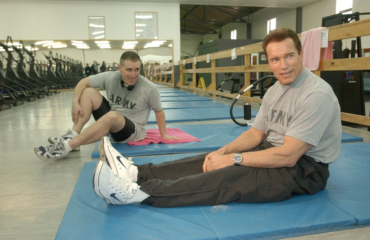 Actor Arnold Schwarzenegger taking break during workout with US Army troops stationed in Bosnia