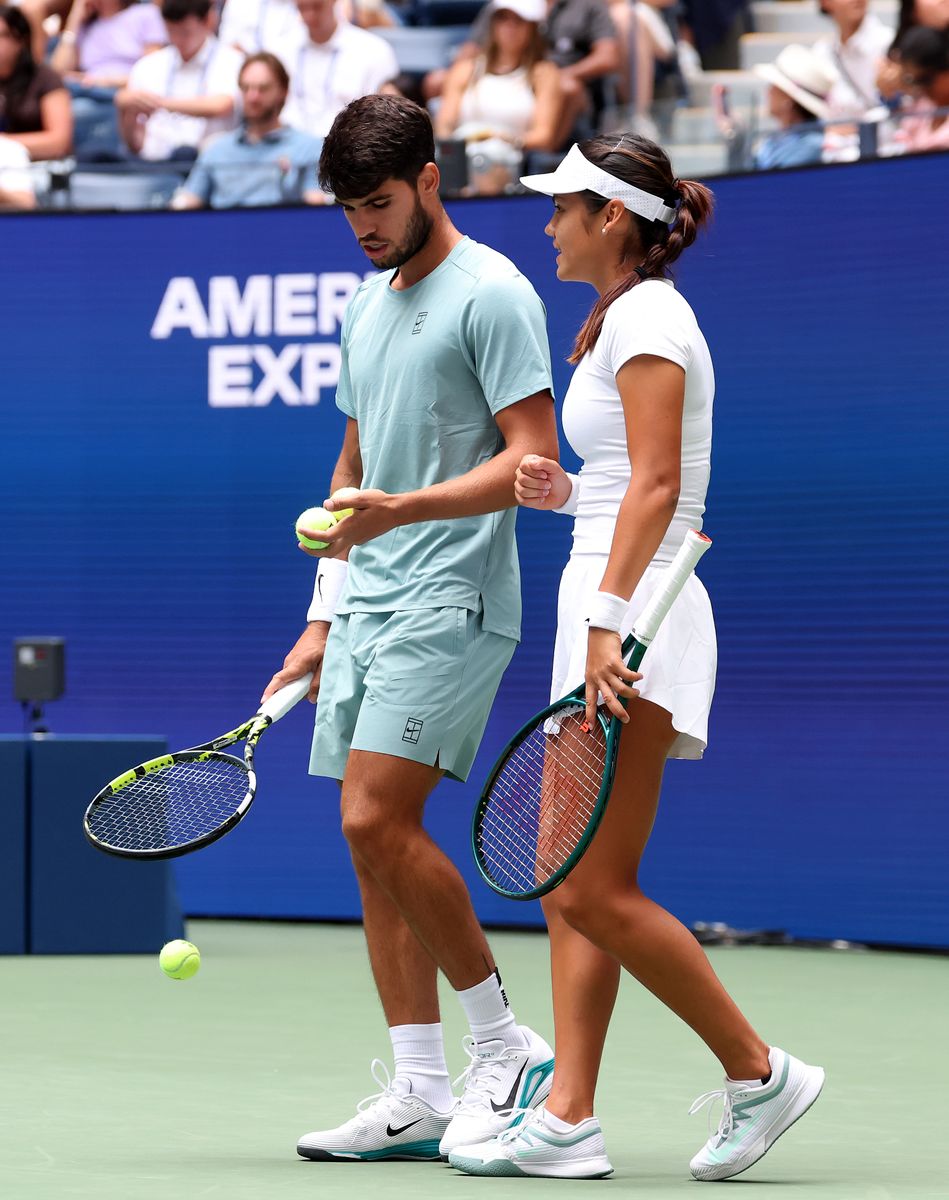 NEW YORK, NEW YORK - AUGUST 19:  The doubles team of Emma Raducanu of Great Britain and Carlos Alcarez of Spain talk on the baseline during the mixed doubles first round match against Jessica Pegula of the United States and Jack Draper of Great Britain at USTA Billie Jean King National Tennis Center on August 19, 2025 in New York City. (Photo by Elsa/Getty Images)