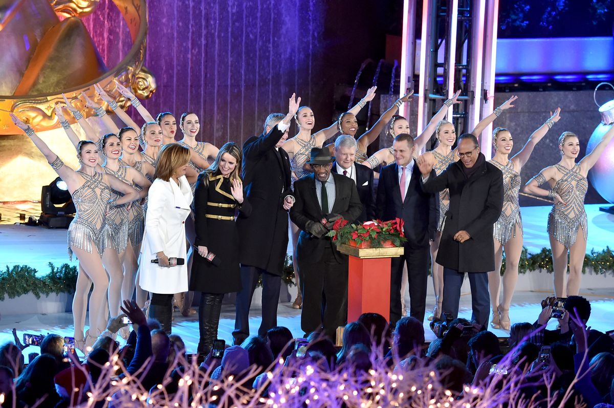 Hoda Kotb, Savannah Guthrie, Al Roker, and Lester Holt press the tree-lighting button during the Rockefeller Center Christmas Tree Lighting Ceremony at Rockefeller Center.