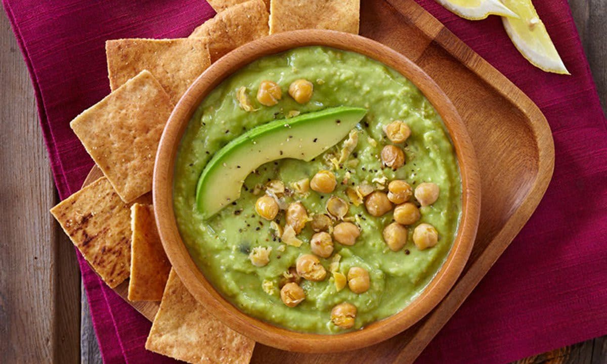 Bowl of Avocado Hummus and chips.