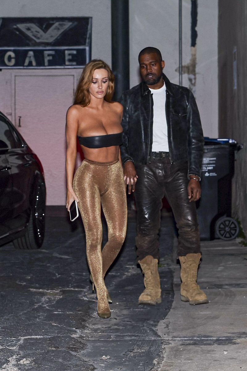 Bianca Censori embraces her signature barely-there style with glittering tights and metallic heels for a comedy date night.