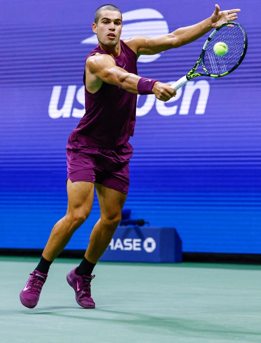 Carlos Alcaraz plays a backhand return to USA's Reilly Opelka during their men's singles first round tennis match on day two of the US Open 