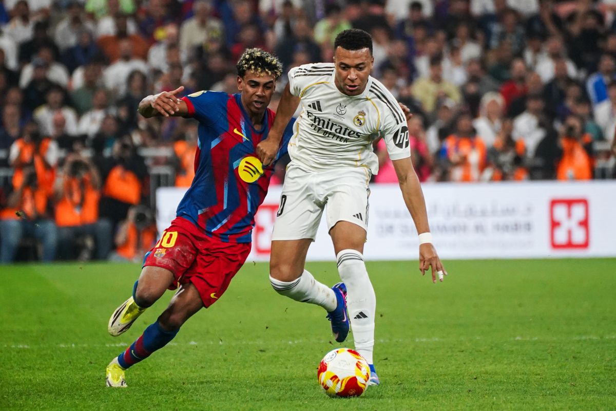 Kylian Mbappe of Real Madrid in action against Lamine Yamal of Barcelona during the Spanish Super Cup final match between FC Barcelona and Real Madrid at King Abdullah Sports City Hall Stadium in 2026