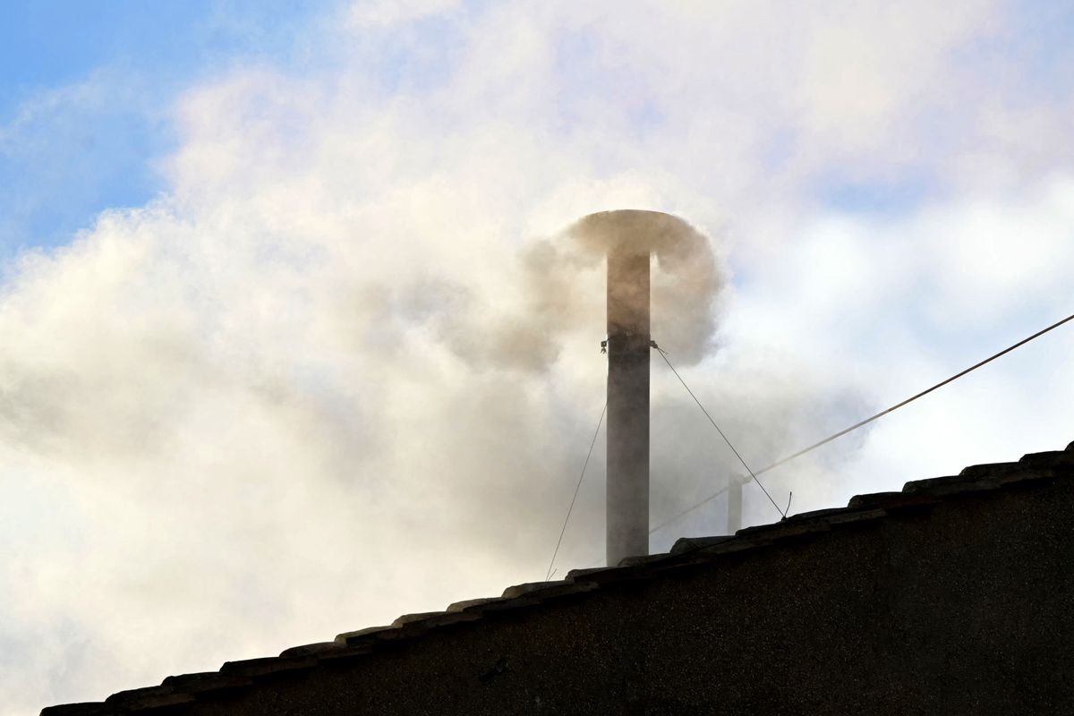 White smoke rising from the chinmey of the Sistine Chapel signaling that cardinals elected a new pope during their conclave in the Vatican on May 8, 2025. 