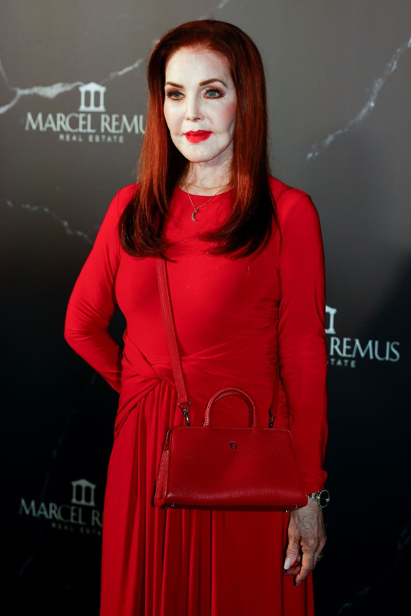 Priscilla Presley completed her monochromatic look with a matching red handbag, sleek auburn hair and bold scarlet lipstick at the glamorous Mallorca event.