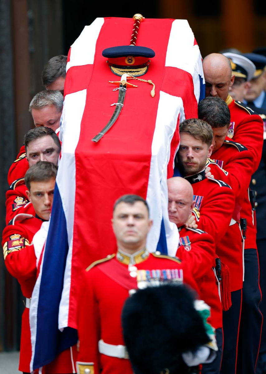 Welsh Guards pallbearers in military uniform carry Field Marshal Lord Guthrie’s coffin following his funeral at Westminster Cathedral.