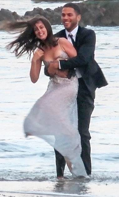 Ana De Arma shares a kiss with a male model on set of a perfume commercial