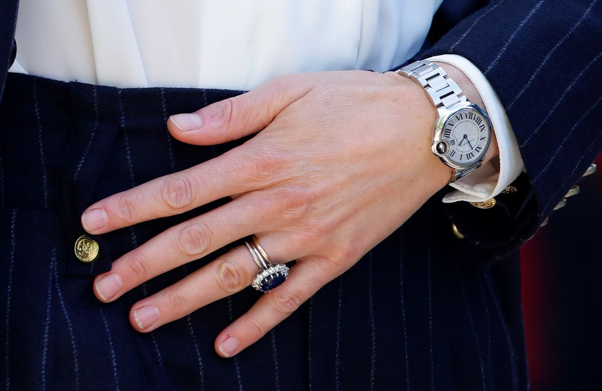 Kate Middleton's Cartier Ballon Bleu watch, reportedly a wedding anniversary gift from Prince William, complements her iconic sapphire engagement ring, which once belonged to Princess Diana.