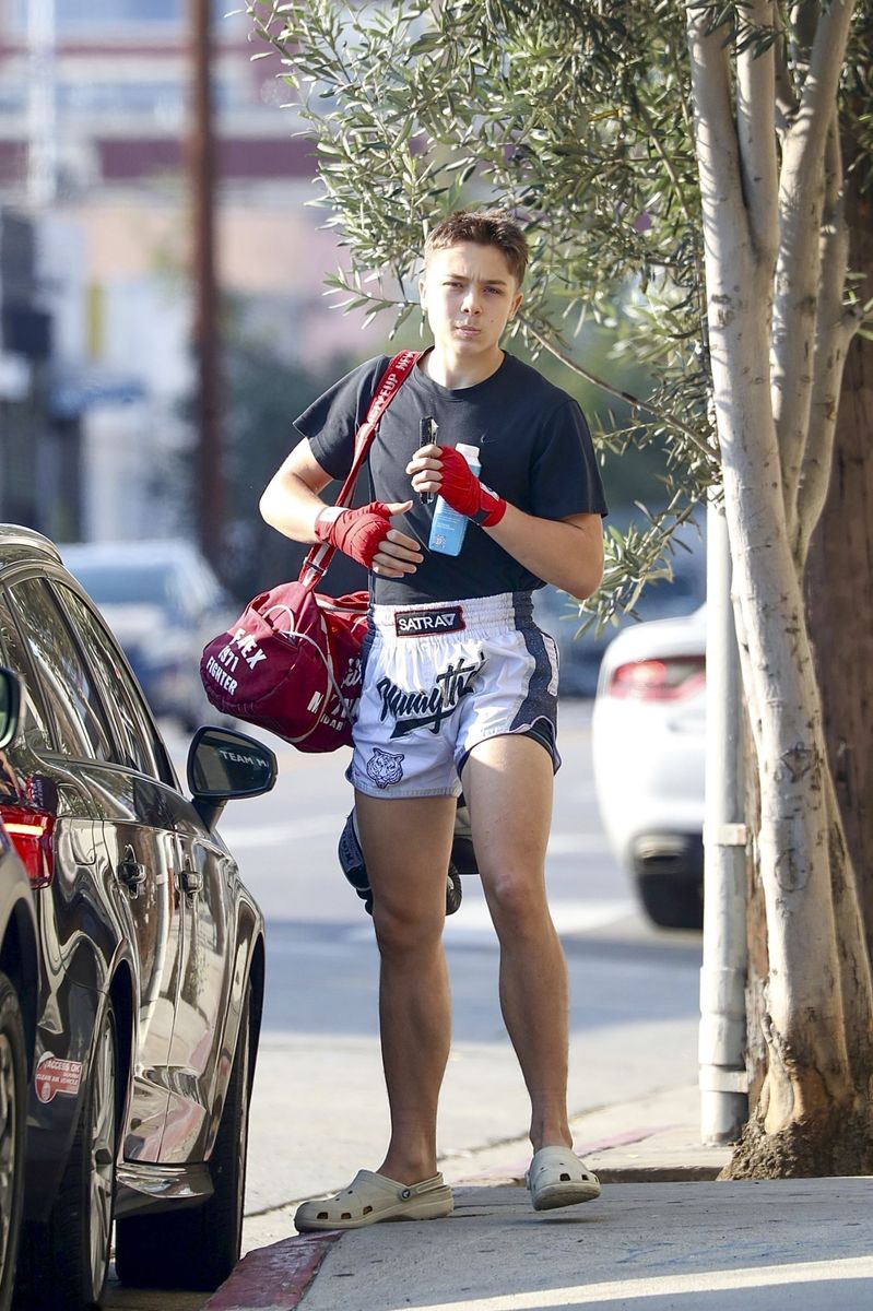Knox Léon Jolie-Pitt was seen flexing after a weekend Muay Thai victory in Los Angeles. Dressed in fighter shorts, red wraps, and Crocs, the 16-year-old appeared focused and fierce as he headed to training, still energized from his recent tournament triumph.
****
Knox Léon Jolie-Pitt fue visto presumiendo de su victoria en Muay Thai durante el fin de semana en Los Ángeles. Con pantalones cortos de luchador, vendas rojas y Crocs, el joven de 16 años lucía concentrado y feroz mientras se dirigía al entrenamiento, aún lleno de energía tras su reciente triunfo en el torneo.