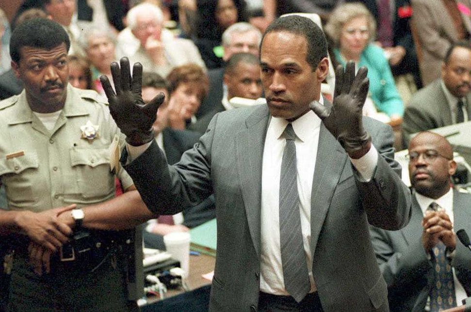 O.J. Simpson shows the jury a new pair of Aris extra-large gloves, similar to the gloves found at the Bundy and Rockingham crime scene 