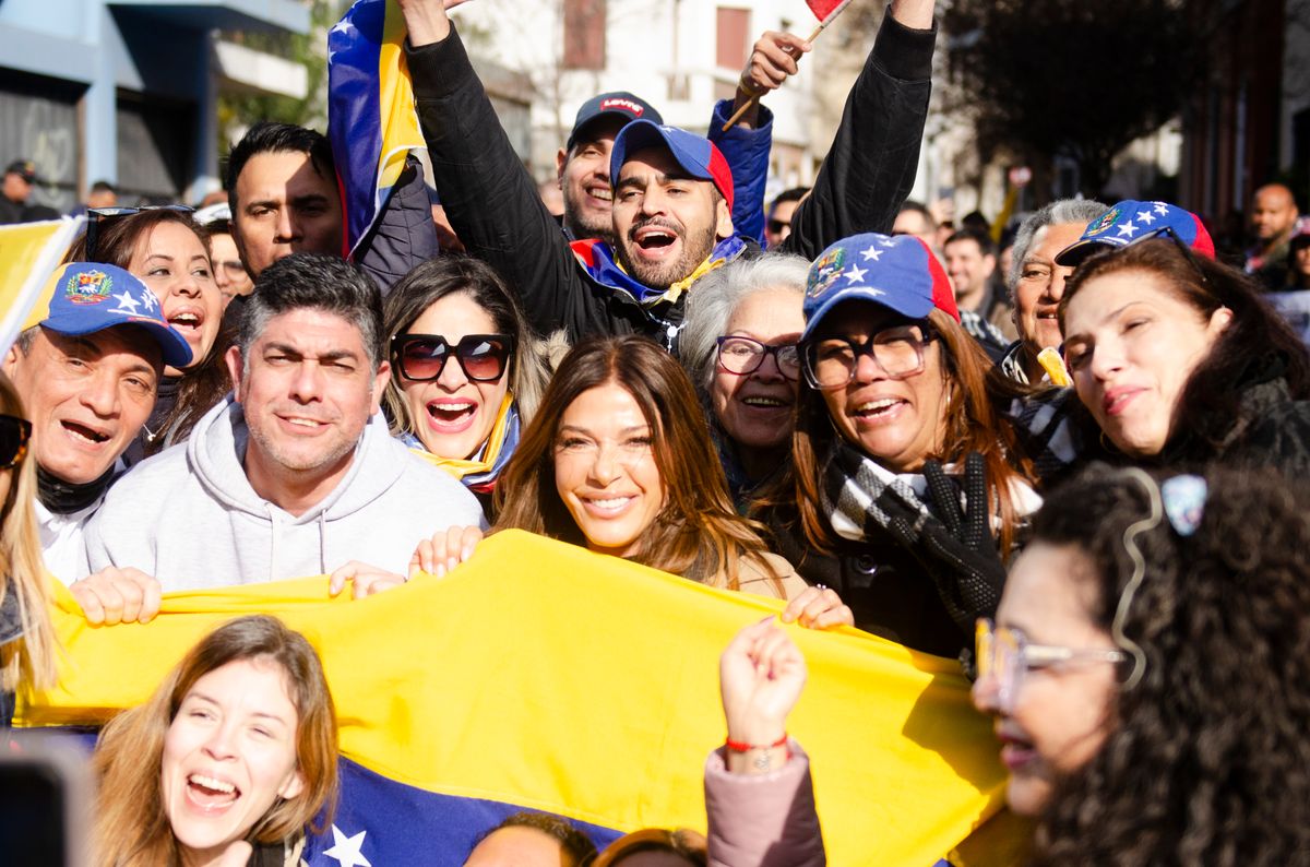 Rafael Monsalve, president of the Venezuelan Association and Catherine Fulop pose next to Venezuelan citizens during the Venezuelan elections 2024. 