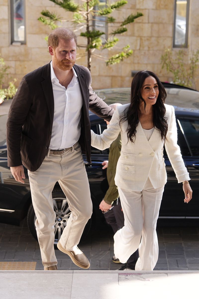 Meghan Markle channels Carolyn Bessette-Kennedy in corset-style gown with sleek column silhouette and heirloom gold jewelry