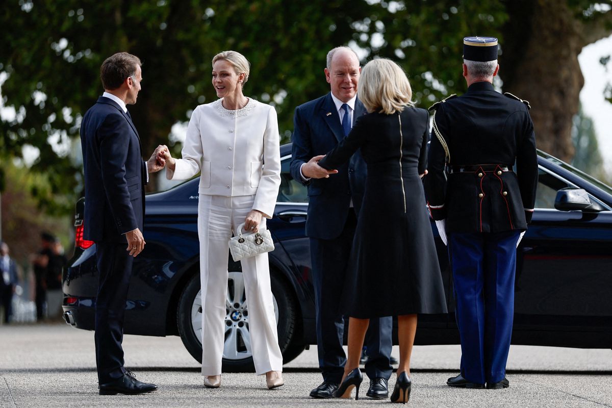 French President Emmanuel Macron (L) and his wife Brigitte Macron (R) welcome Prince Albert II (2nd R) and Princess Charlene (2nd L) of Monaco
