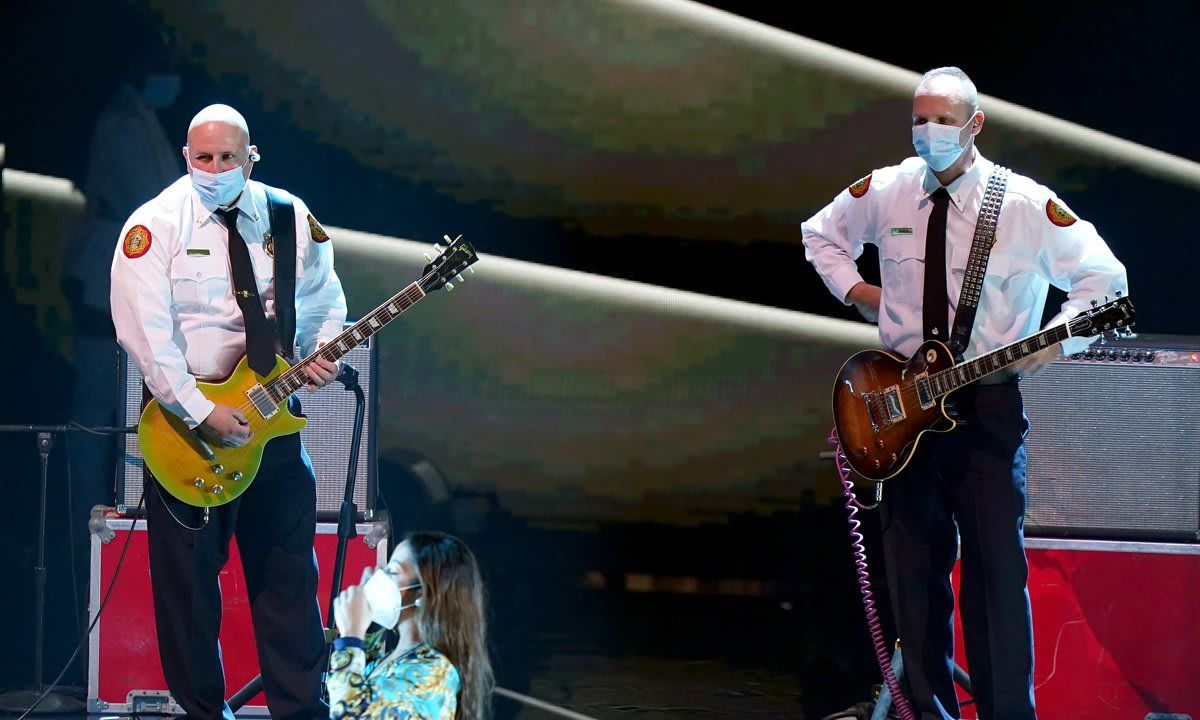 Captain Eddy Alarcón and Lt. Troy Maness in the guitars during the 2020 Latin Grammy Awards.