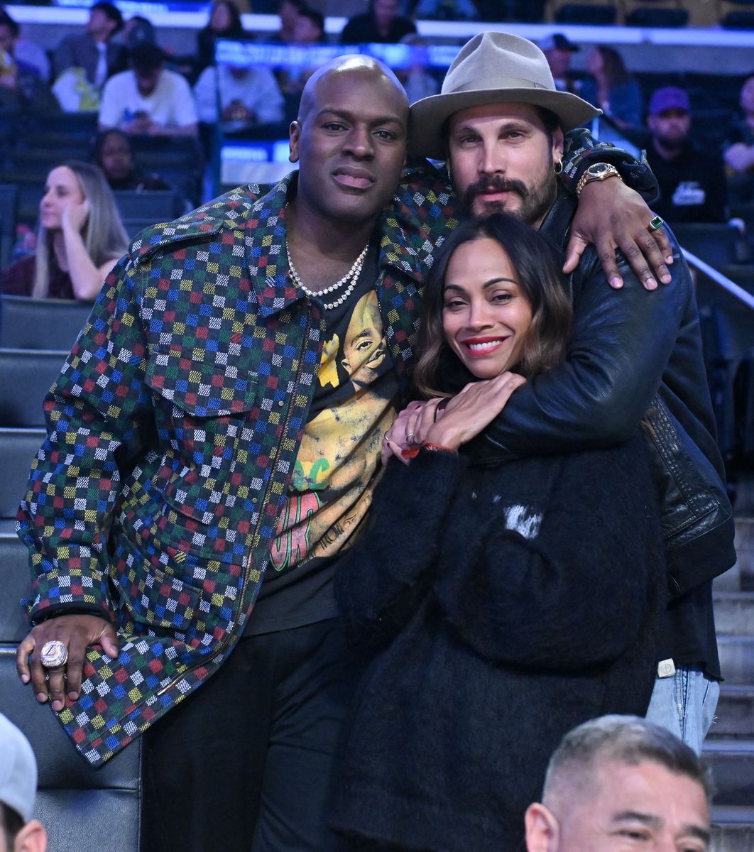  Corey Gamble (L), Marco Perego-Saldana and Zoe Saldana attend a basketball game between the Los Angeles Lakers and the Golden State Warriors at Crypto.com Arena on April 03, 2025 in Los Angeles, California. 