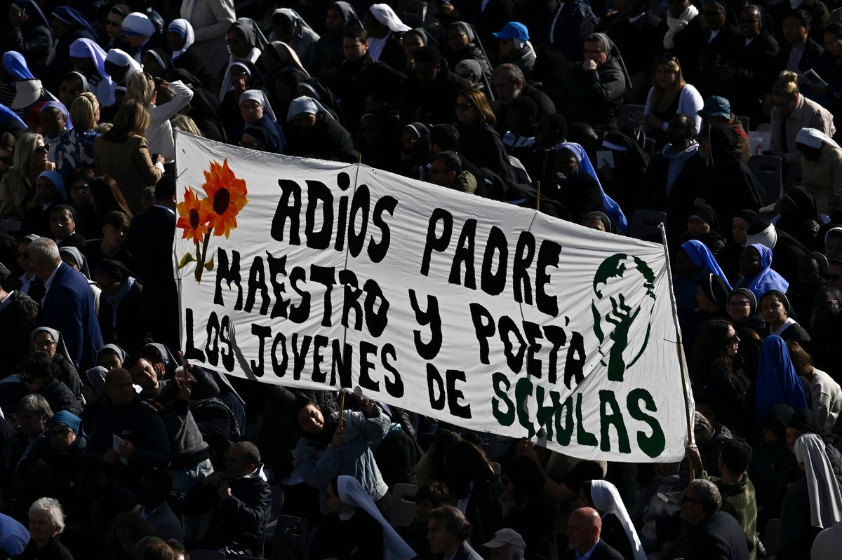 Attendees hold a banner during the funeral of Pope Francis in St. Peter's Square on April 26, 2025 in Vatican City, Vatican. 