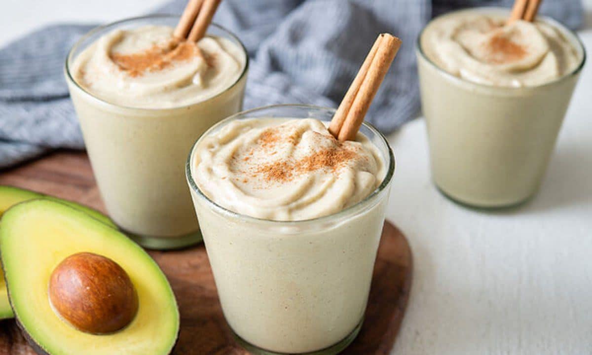 Three glasses of delicious smoothies containing avocado.