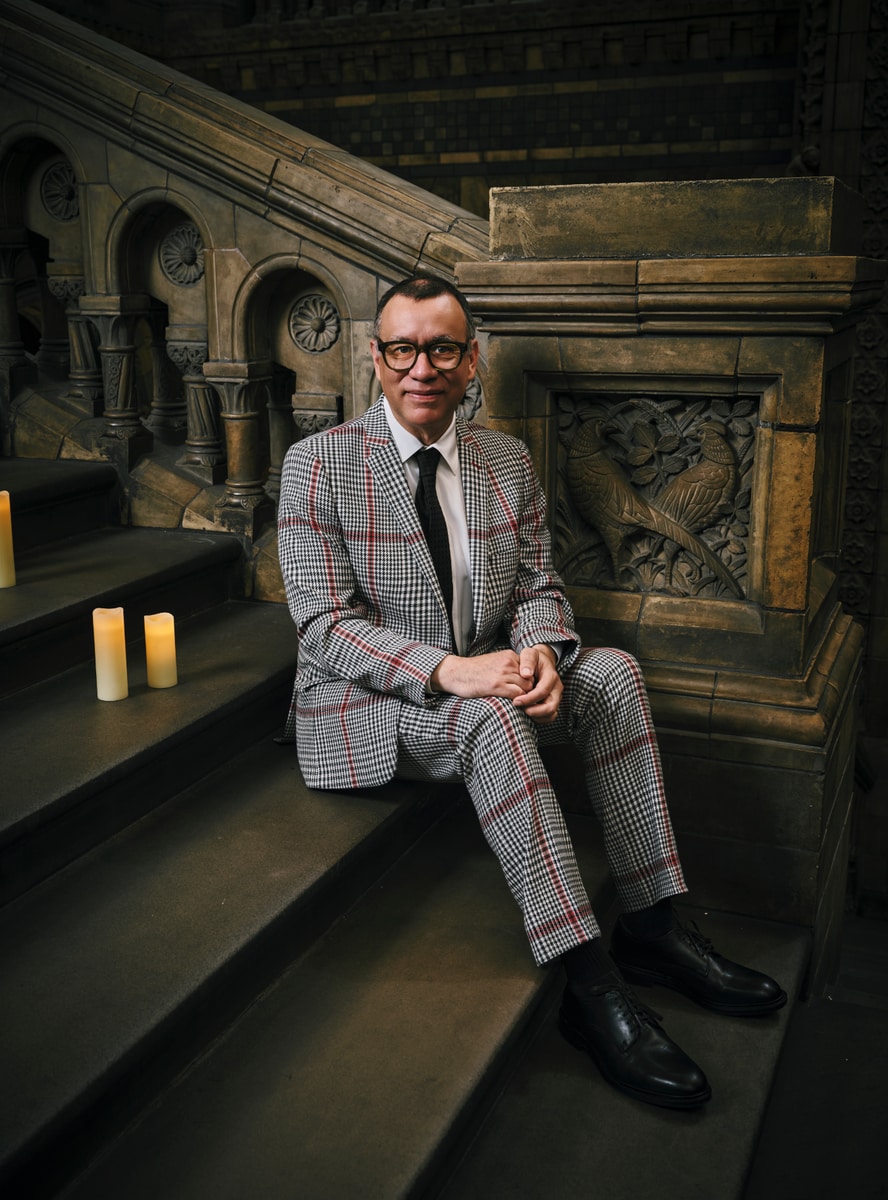 Fred Armisen, playing Uncle Fester, chose a bold black, red, and white dogtooth suit