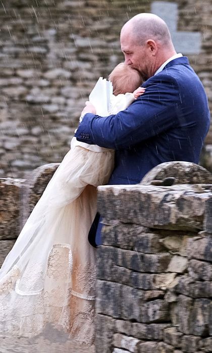 Mike Tindall carries Lena Tindall at christening