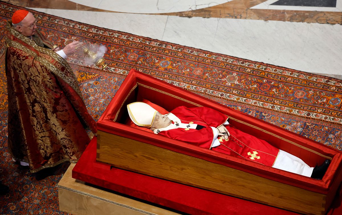 Irish-born US Cardinal Kevin Joseph Farrell holds incense next to Pope Francis' coffin on April 23, 2025 in Vatican City, Vatican. 