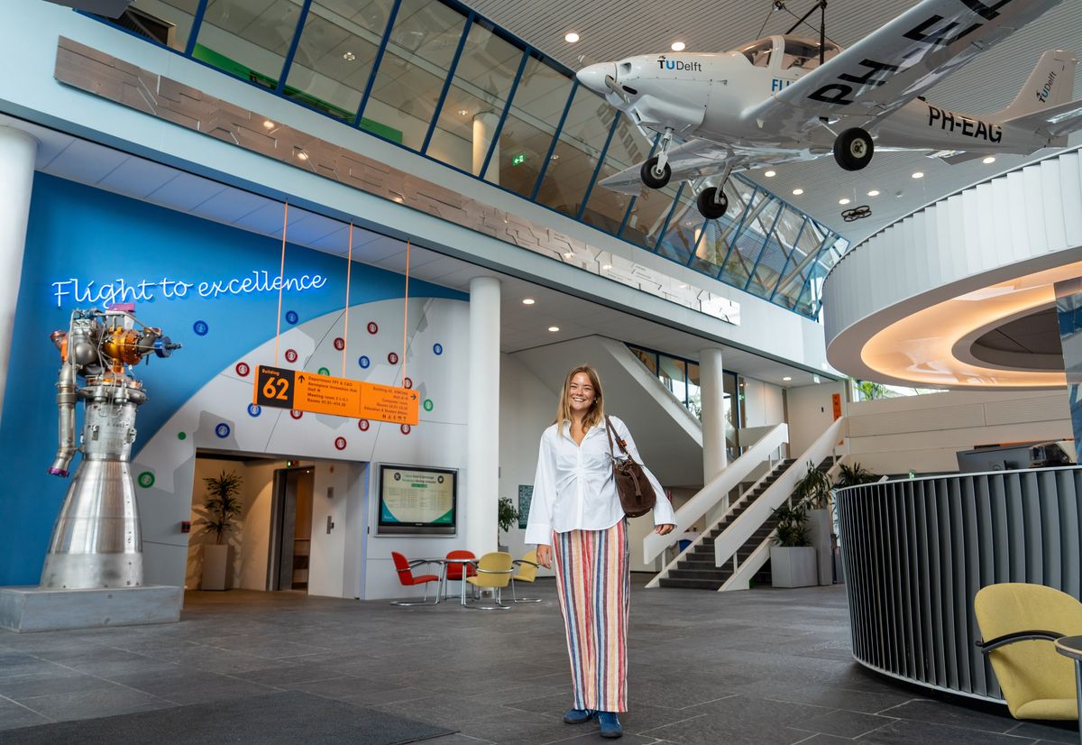 The 19-year-old princess poses beneath a suspended aircraft inside TU Delft, where she will study aerospace engineering.