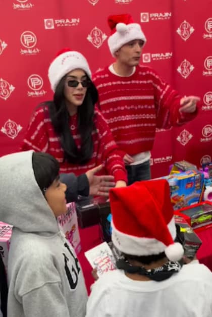 Kenia OS and Peso Pluma participated in a toy giveaway for children and families at a Vallarta Supermarkets location